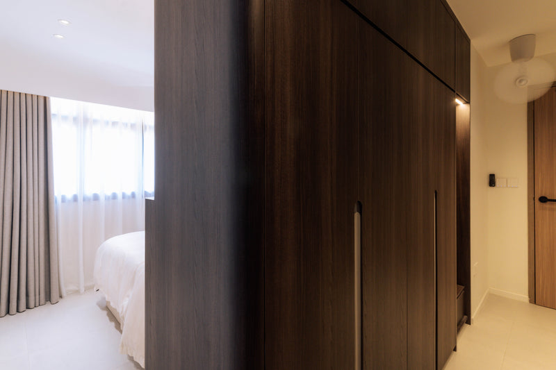 Smart-home wall controls integrated beside a bedroom entrance in a furnished home.