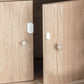 AQARA Door & Window Sensor mounted on a wooden kitchen cabinet