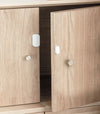 AQARA Door & Window Sensor mounted on a wooden kitchen cabinet