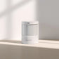 White Motion Sensor P1 on a light beige surface with a soft shadow