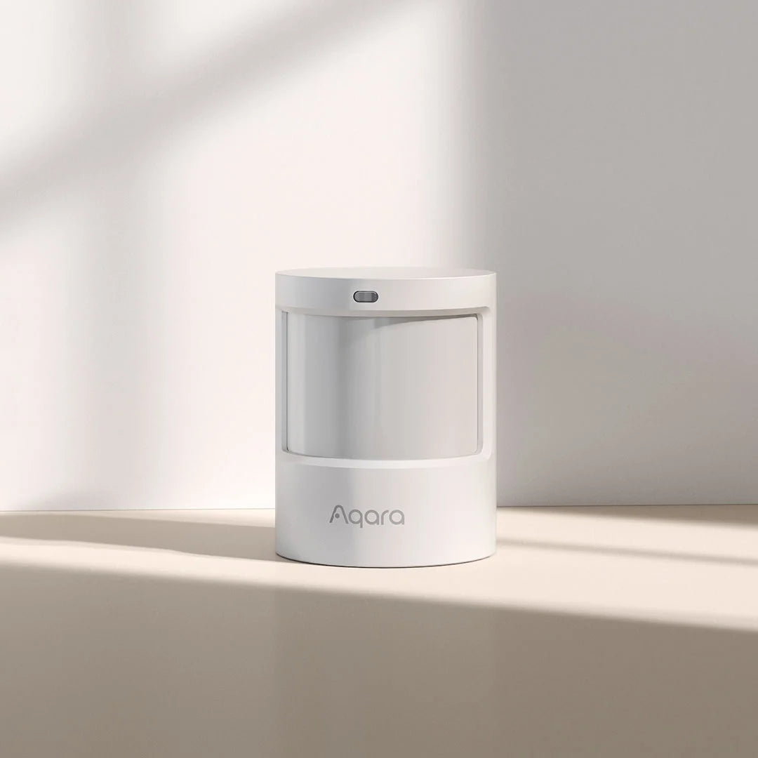 White Motion Sensor P1 on a light beige surface with a soft shadow