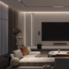 Modern living room with a large sofa, coffee table, and television.