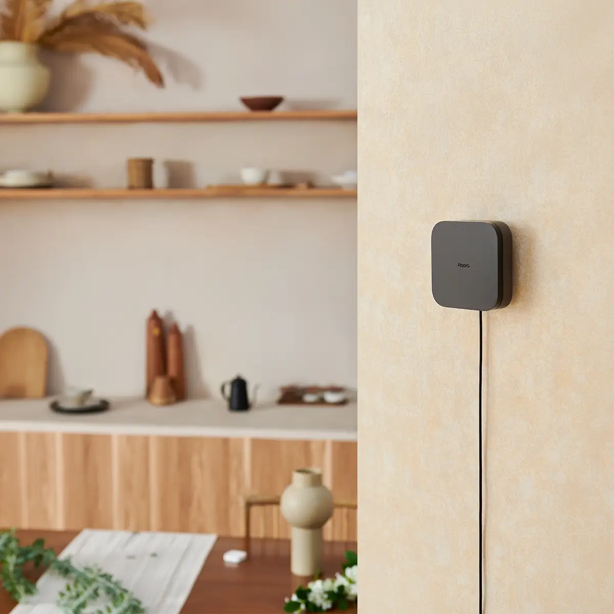 Hub M3 mounted on a wall with a blurred kitchen background