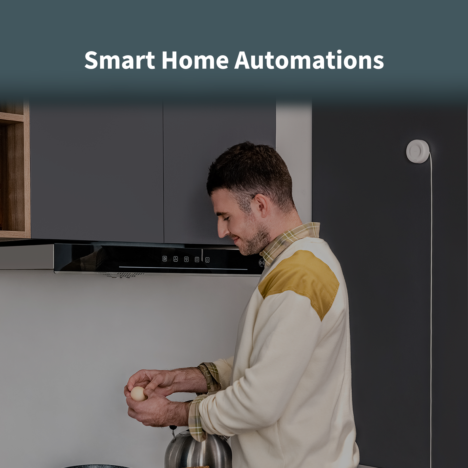 Man preparing food in a kitchen with the Smart Gas Detector mounted on the wall behind him