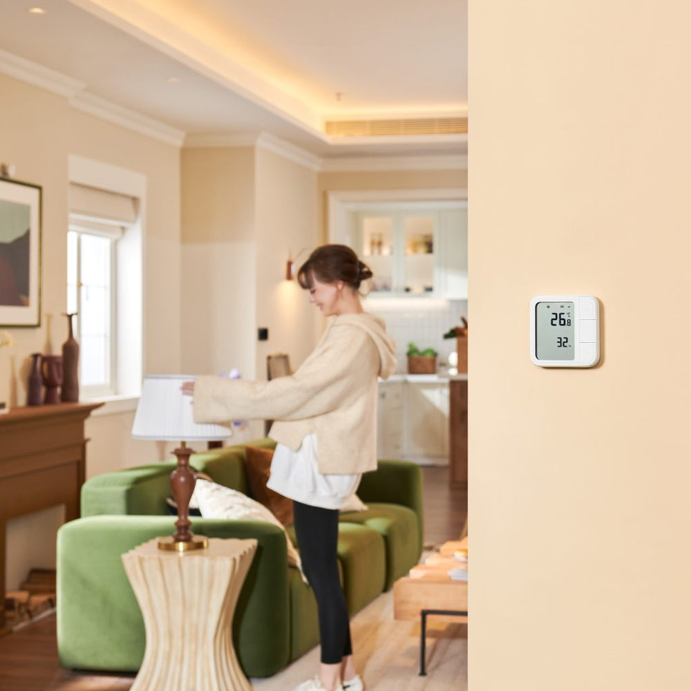 Temperature & Humidity Sensor mounted on the wall of a living room