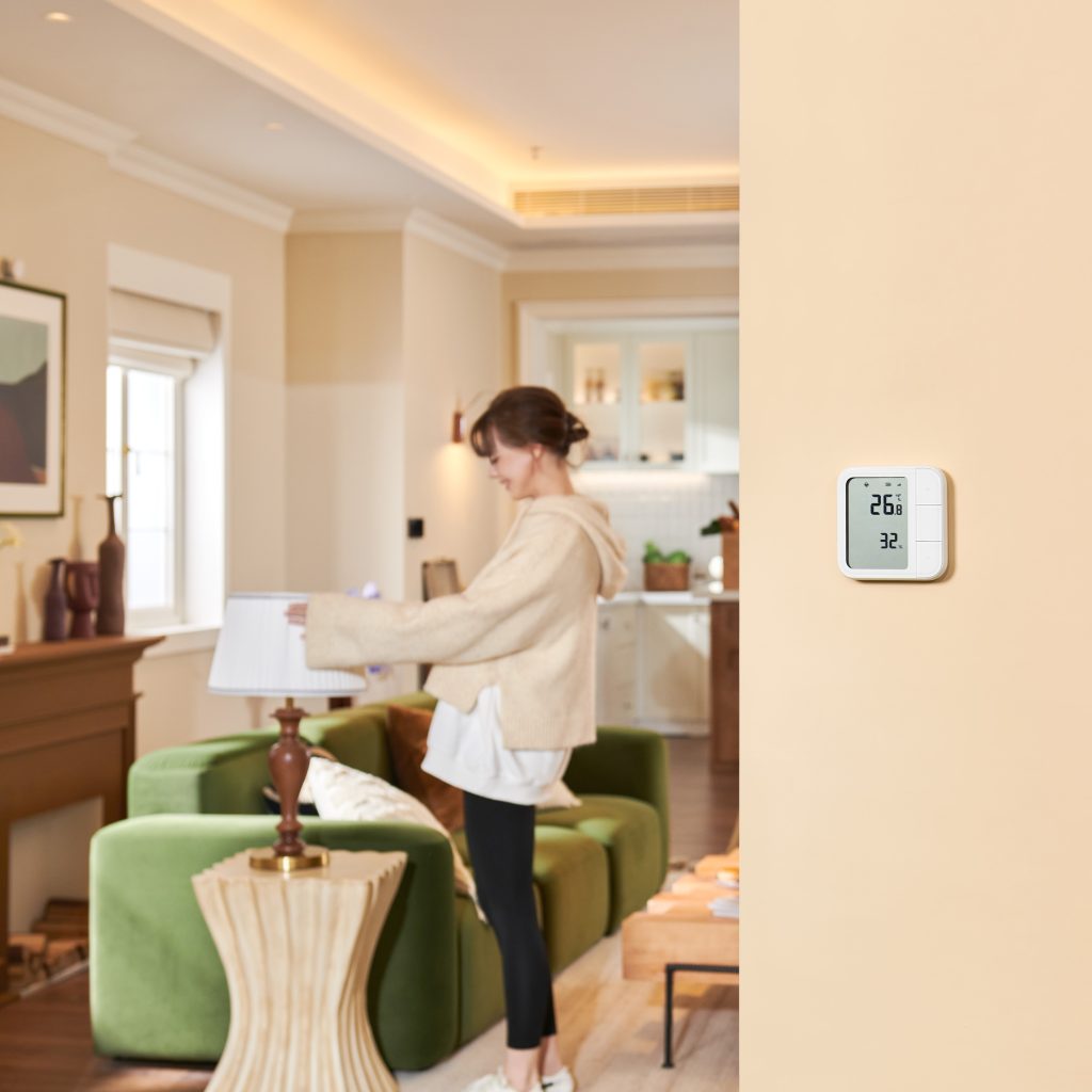 Temperature & Humidity Sensor mounted on the wall of a living room