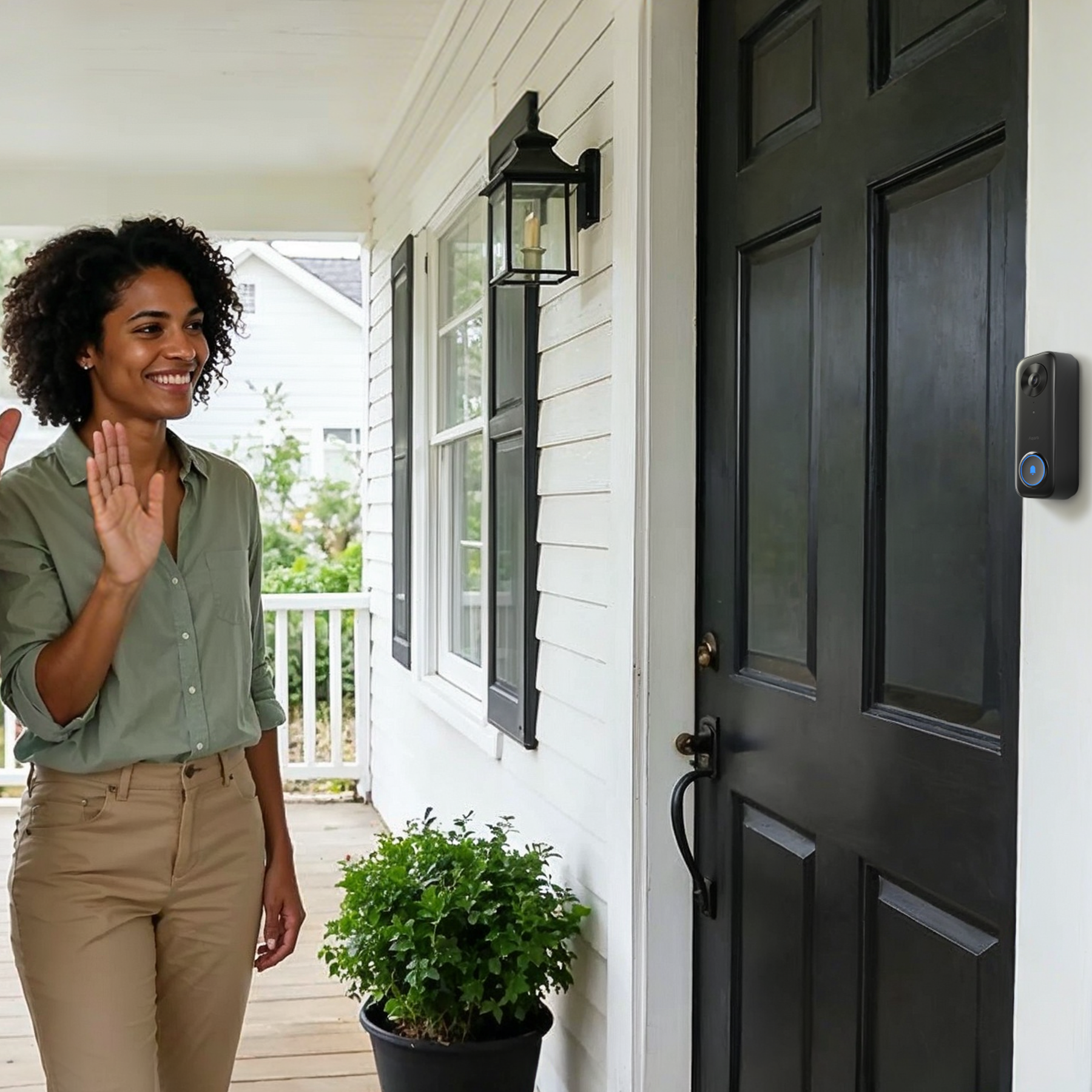 Woman waving at the Wired Doorbell Camera G400 on a porch