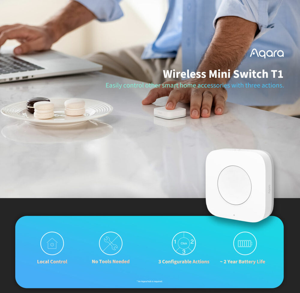 Aqara Wireless Mini Switch T1 being used on a desk with a person using a laptop.