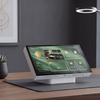 Smart home control panel on a desk with a lamp and plant in the background